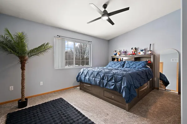a room with lots of white furniture and windows