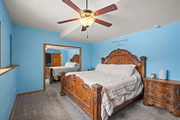 an empty room with a window and a ceiling fan