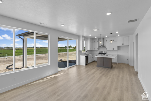 537 South 1150 West Logan, UT 84321 - Photo 8 of 33 Open-concept living area with wood-finish flooring, recessed lighting, and large windows