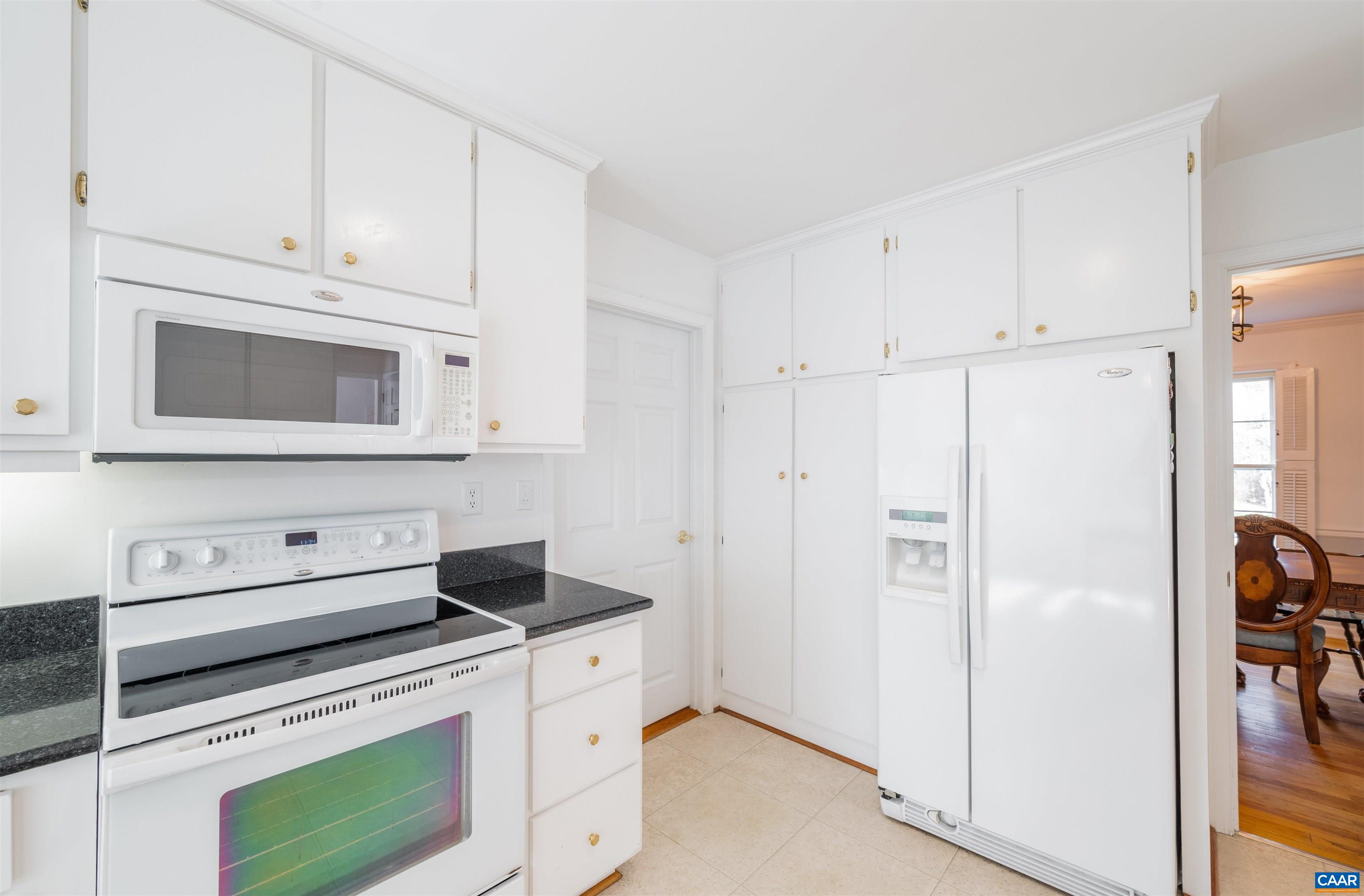2403 Bennington Road Charlottesville, VA 22901 - Photo 12 of 31 a kitchen with white cabinets and white appliances