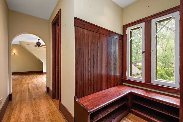a bedroom with a large bed a chandelier and a window