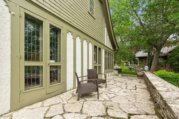 a front view of a house with a yard and potted plants