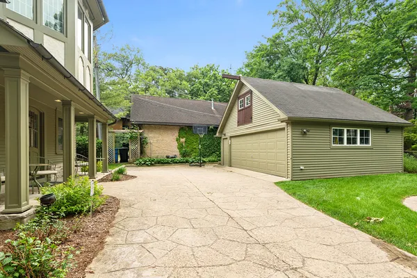 a front view of a house with a yard and trees