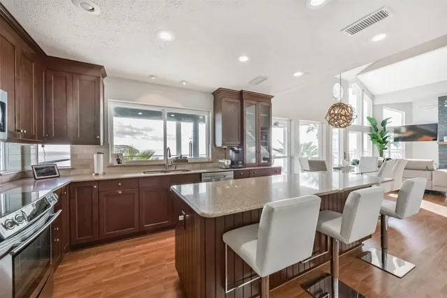 a kitchen with sink a window and cabinets