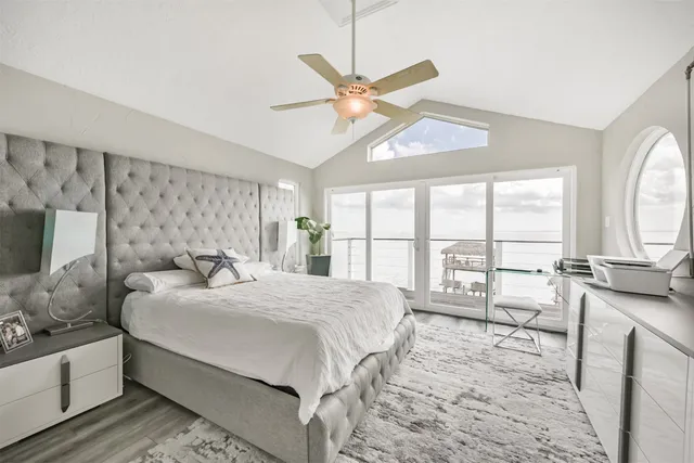 a bedroom with a large bed and a chandelier