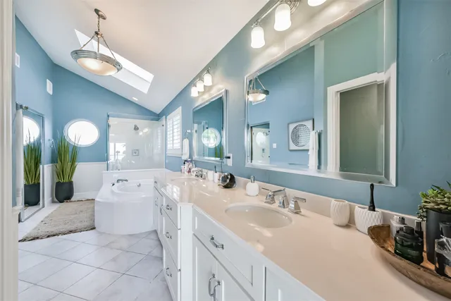 a bathroom with a granite countertop sink mirror and double