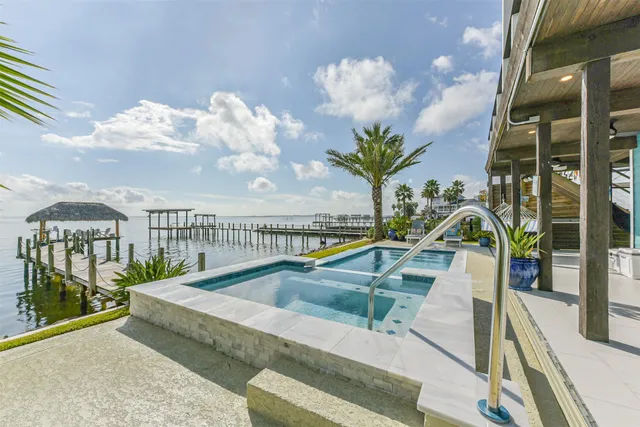 a view of small pool with seating area