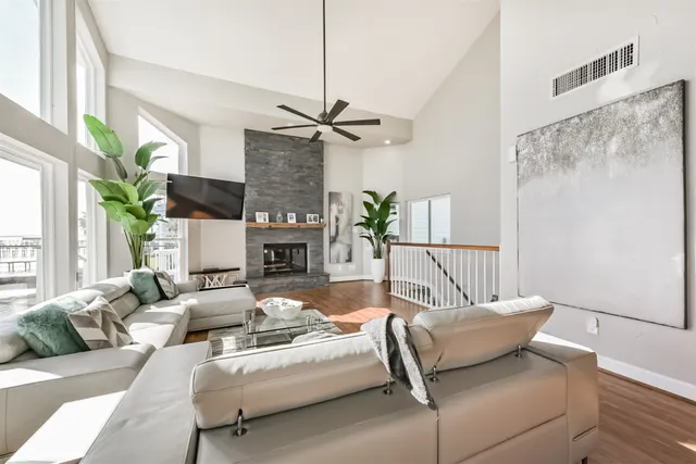 a living room with furniture chandelier and a table