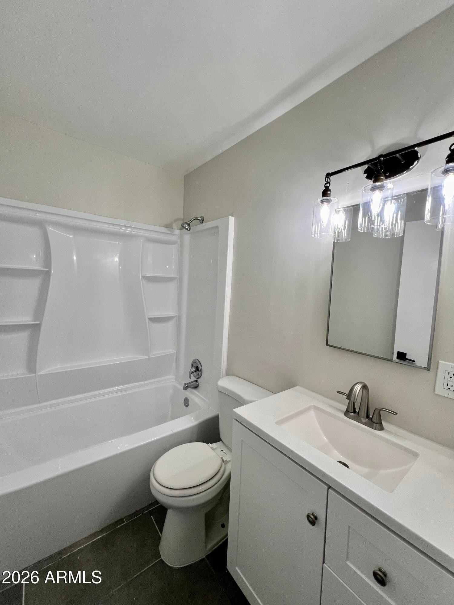 1973 East 10th Street, Unit B Tempe, AZ 85281 - Photo 5 of 6 a bathroom with a toilet a sink a mirror a bathtub and vanity