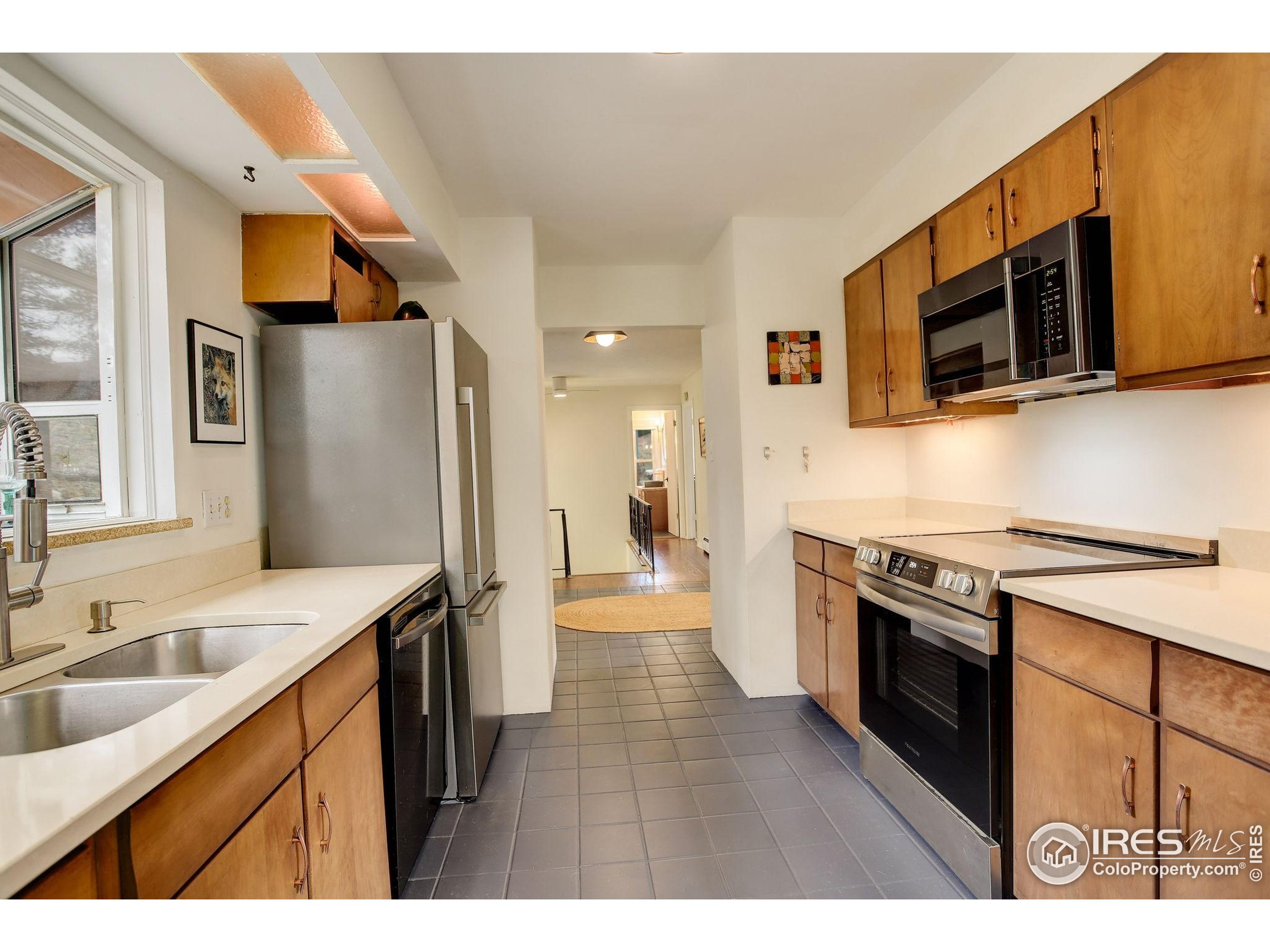 4 Porphyry View Jamestown, CO 80455 - Photo 12 of 36 a kitchen with stainless steel appliances granite countertop a sink stove and microwave