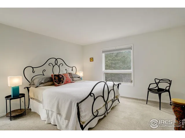 a bedroom with a bed a desk and chair