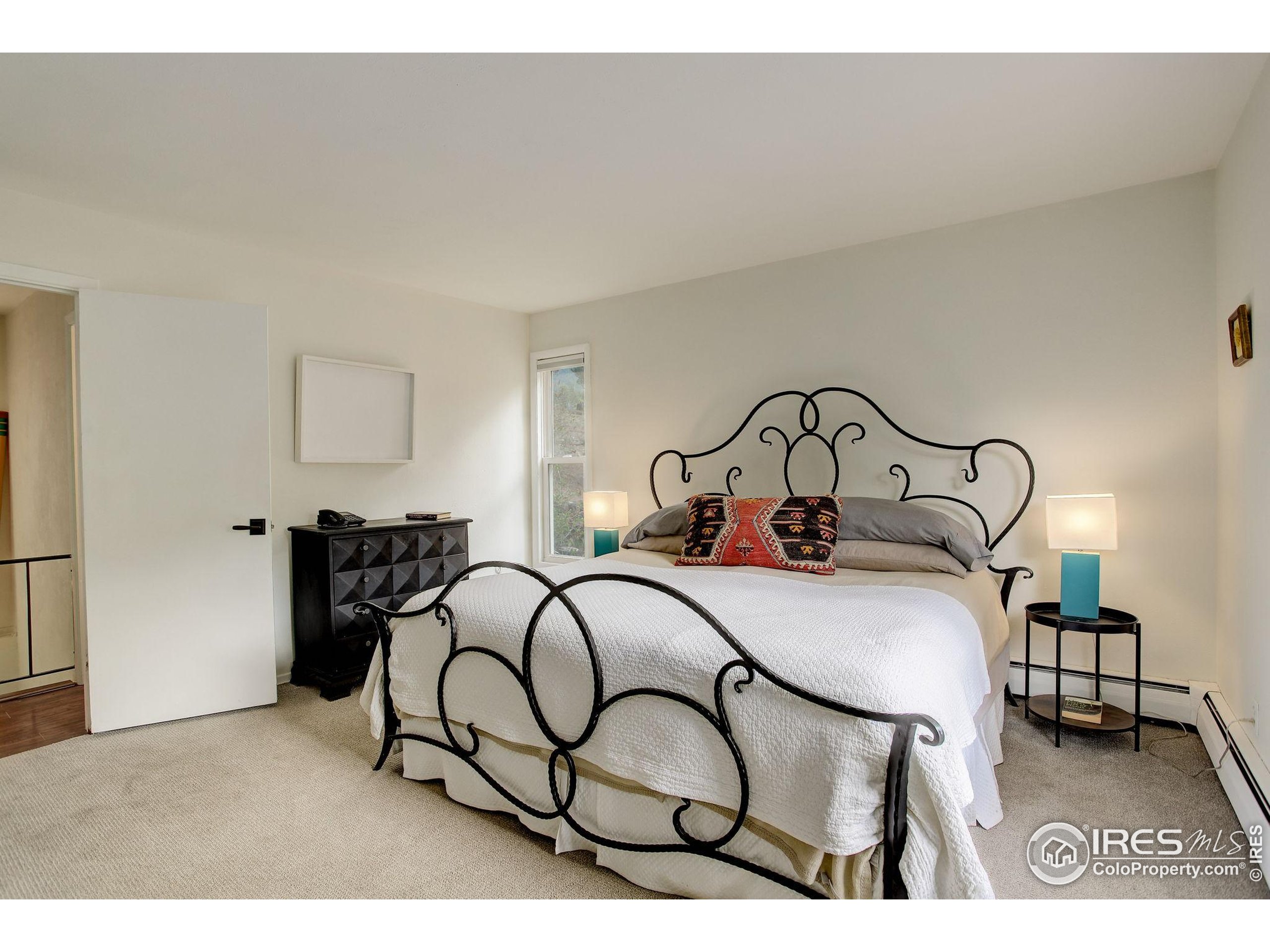 4 Porphyry View Jamestown, CO 80455 - Photo 14 of 36 a bedroom with a bed and a table