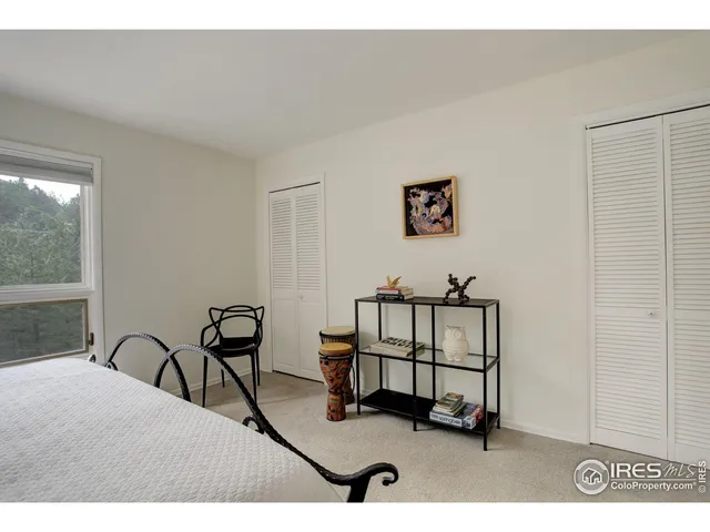 a living room with furniture a window and a potted plant
