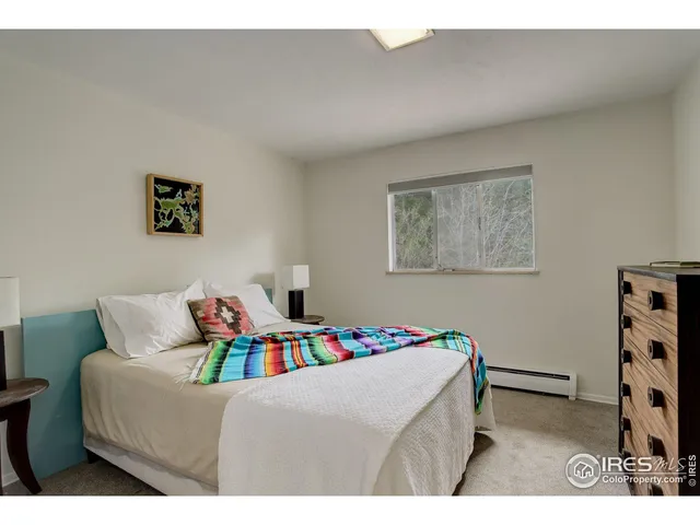 a bedroom with a bed and a bookshelf