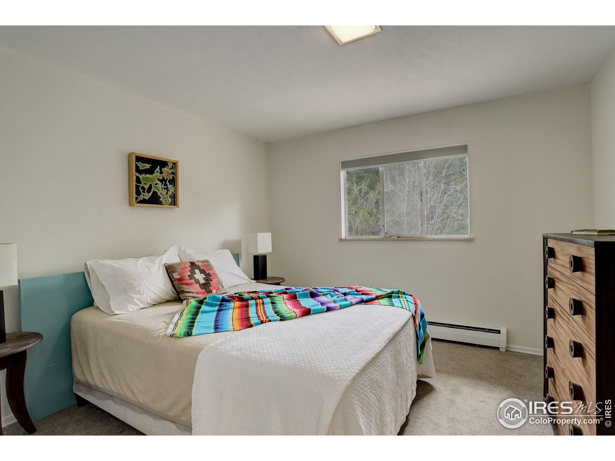 4 Porphyry View Jamestown, CO 80455 - Photo 19 of 36 a bedroom with a bed and a bookshelf