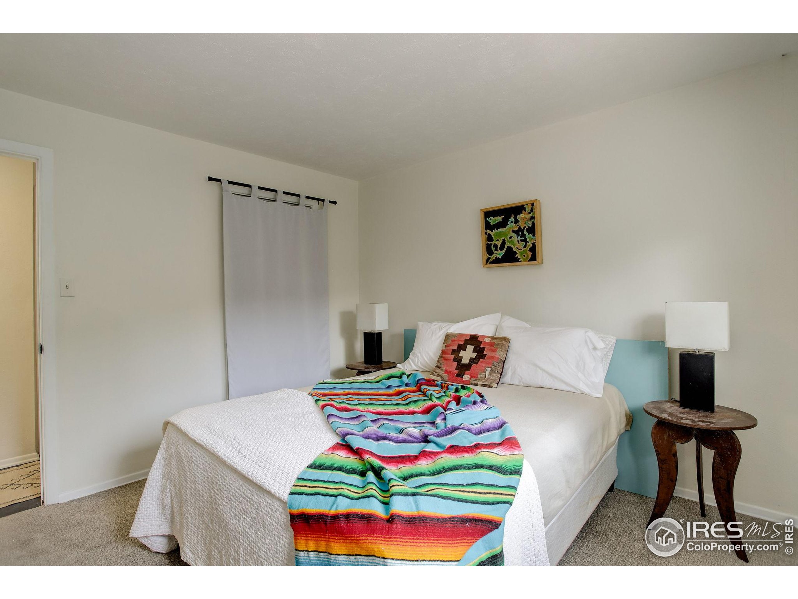 4 Porphyry View Jamestown, CO 80455 - Photo 20 of 36 a bedroom with a bed and wooden floor