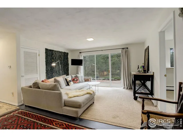 a living room with furniture and a floor to ceiling window
