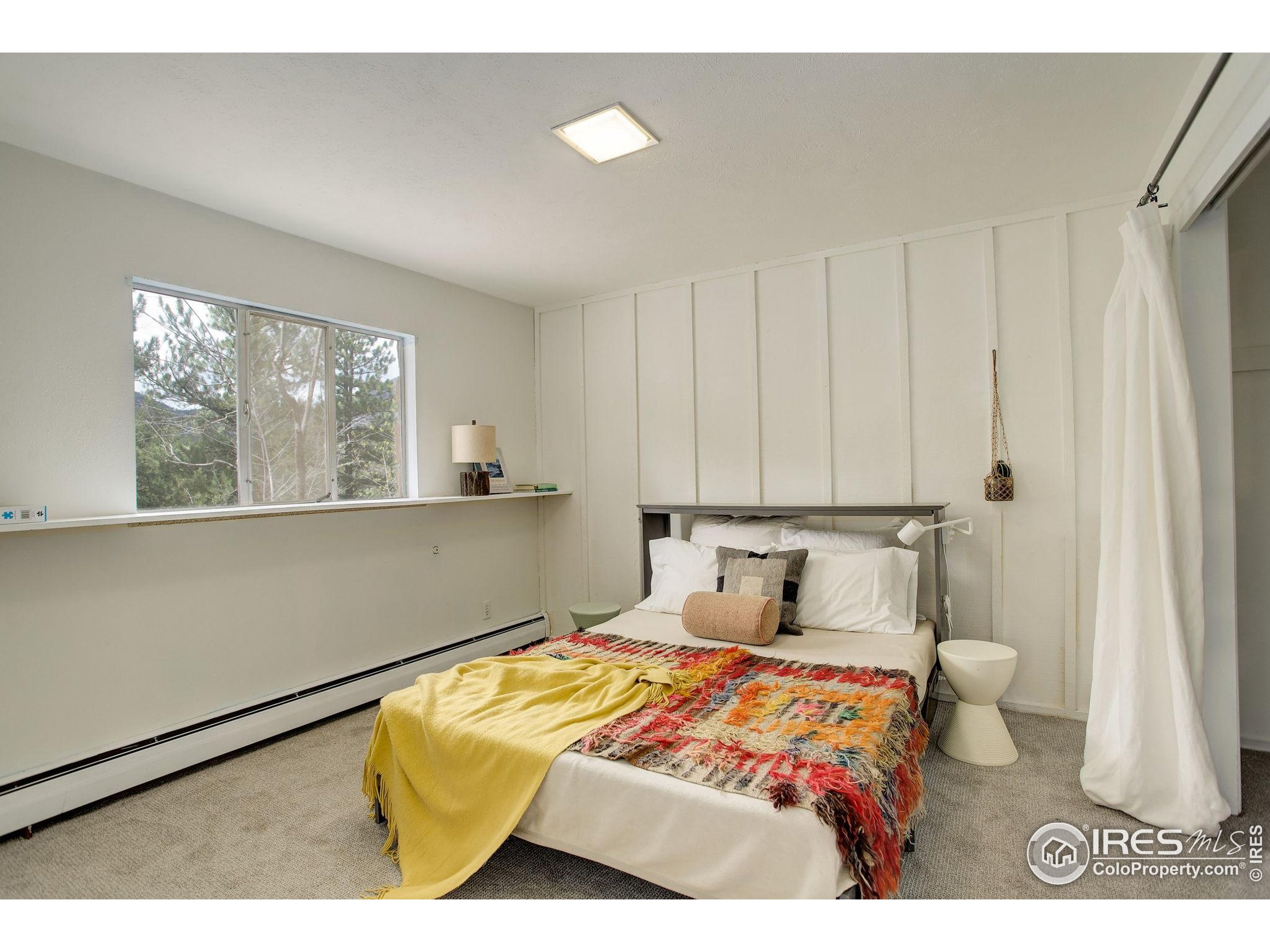 4 Porphyry View Jamestown, CO 80455 - Photo 25 of 36 a bedroom with a bed and window