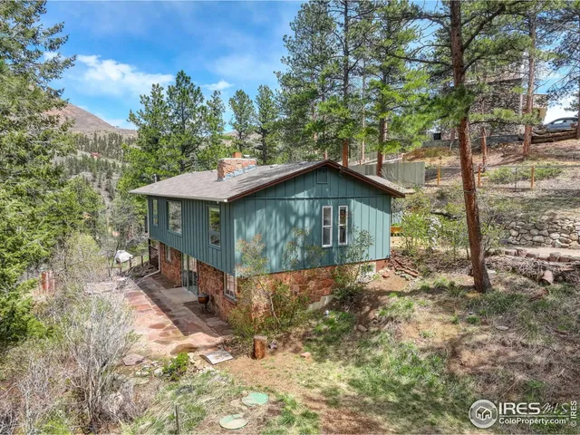 a view of a wooden house with a yard