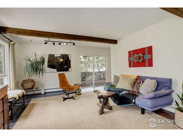 a living room with furniture gym equipment and a large window
