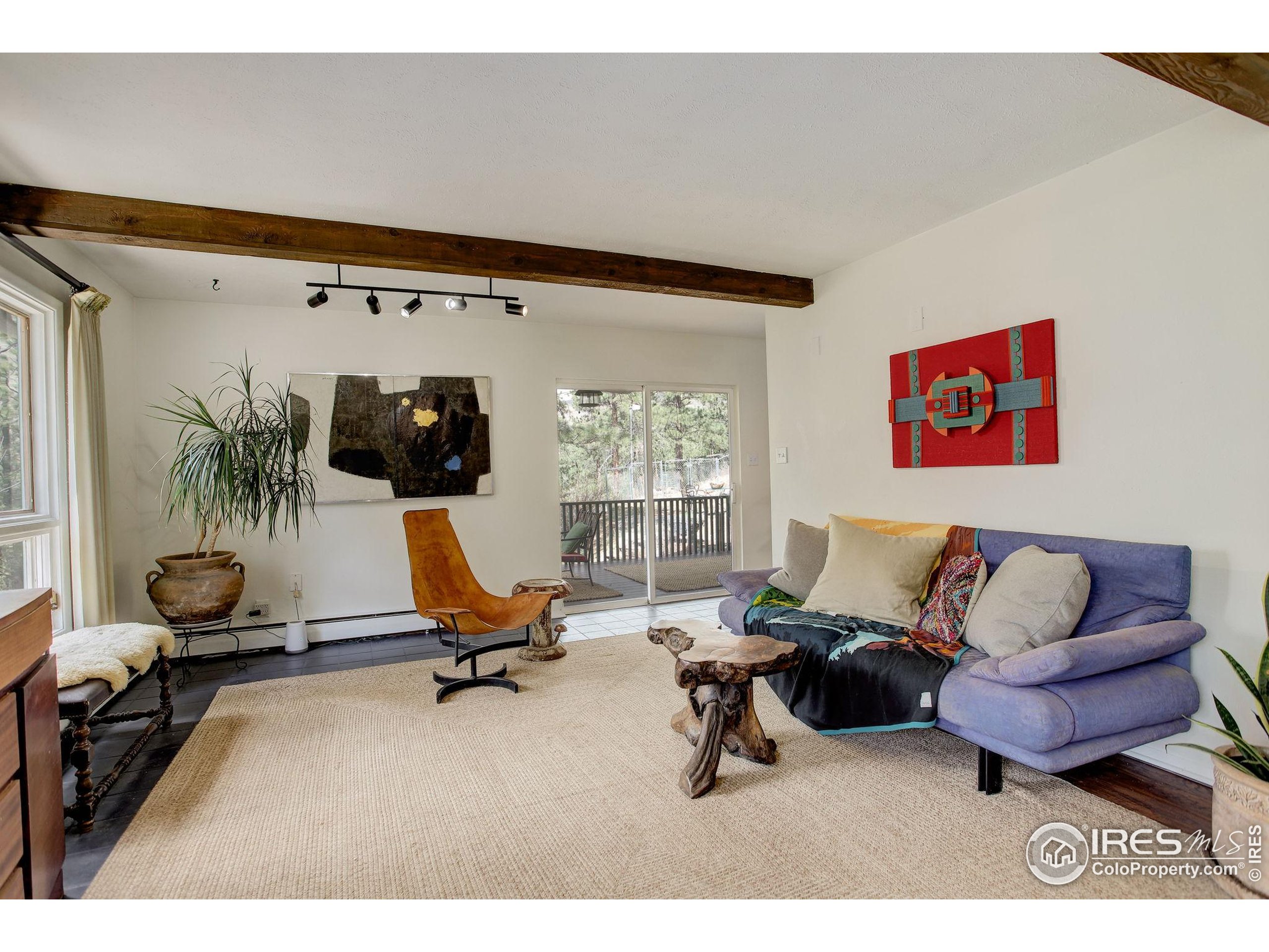 4 Porphyry View Jamestown, CO 80455 - Photo 5 of 36 a living room with furniture gym equipment and a large window