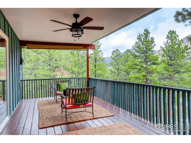 a view of a two chairs in the balcony