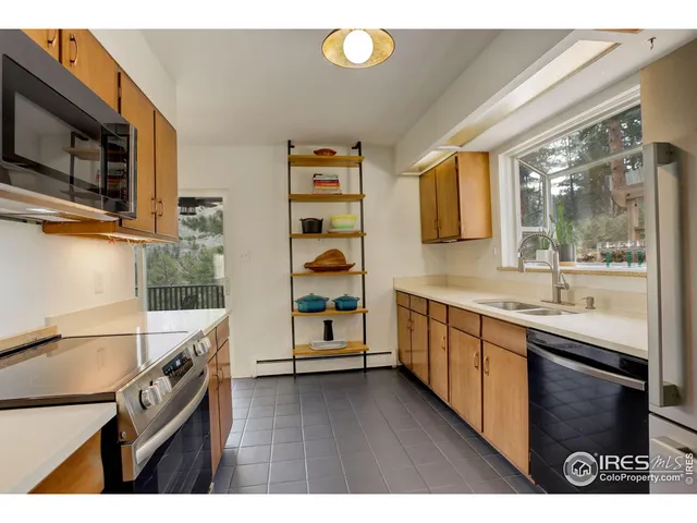 a kitchen with a sink appliances and cabinets
