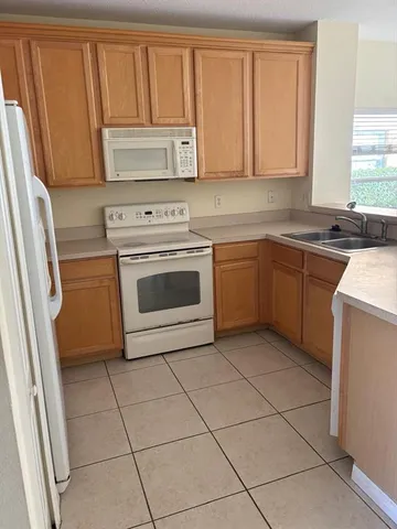 a kitchen with a stove top oven sink and cabinets