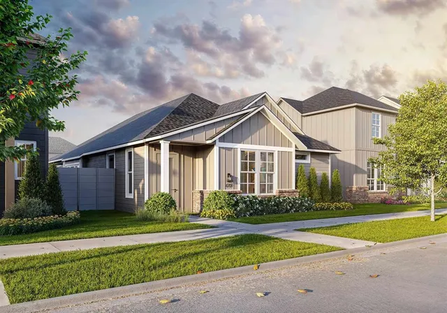 a front view of a house with a yard and potted plants