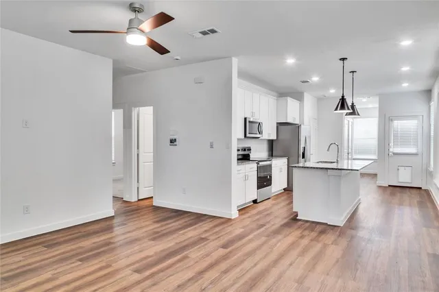 a view of kitchen with wooden floor and window