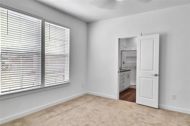 an empty room with windows and closet