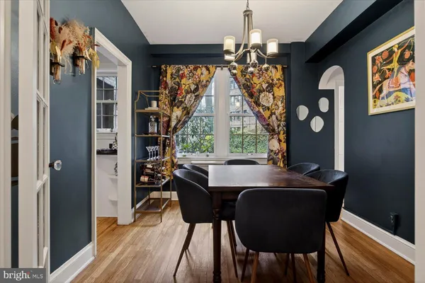 a view of a hallway with a livingroom and furniture