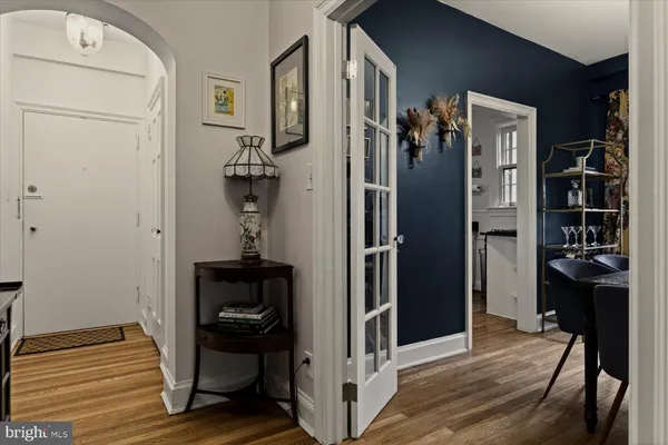 a kitchen with white cabinets and sink