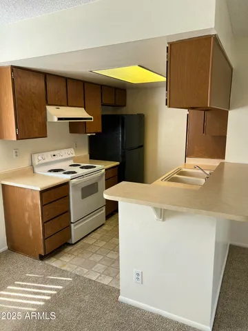 a kitchen with a stove and a refrigerator