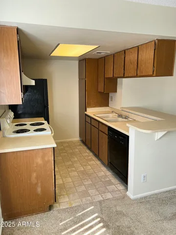 a kitchen with a stove and a refrigerator