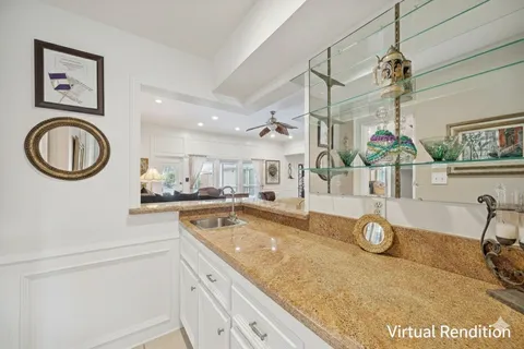 a kitchen with stainless steel appliances granite countertop a sink and dishwasher with white cabinets
