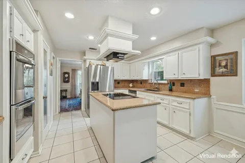 a kitchen with stainless steel appliances granite countertop a refrigerator and a stove top oven