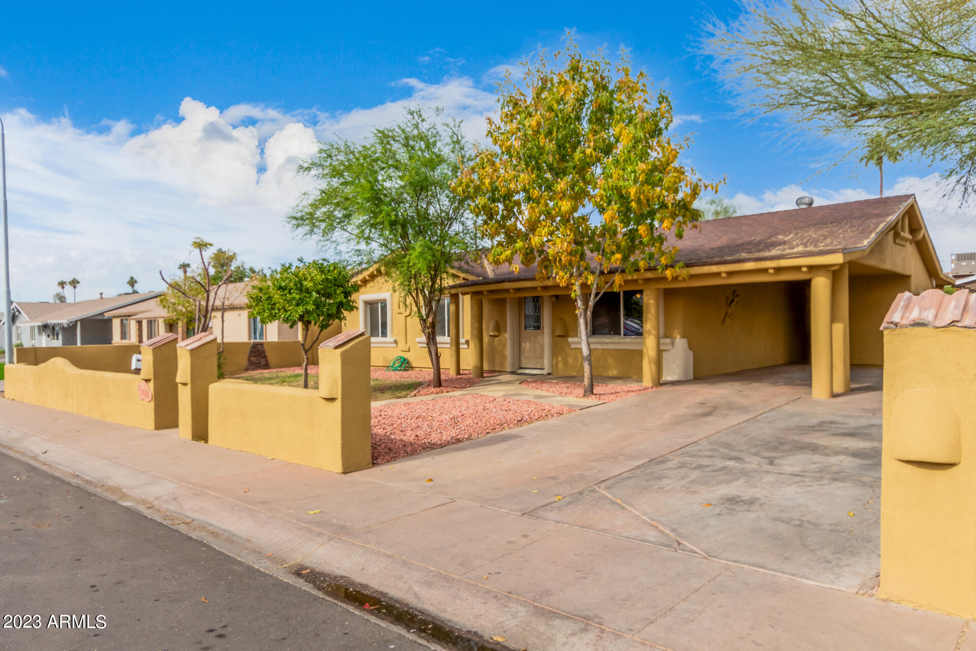 6532 West Granada Road Phoenix, AZ 85035 - Photo 2 of 31 a front view of a house with a yard and garage