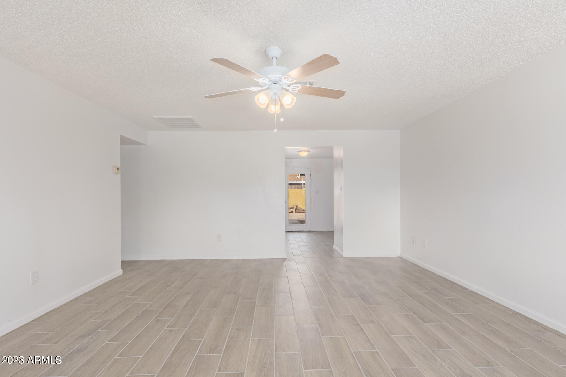 6532 West Granada Road Phoenix, AZ 85035 - Photo 8 of 31 a view of an empty room with wooden floor