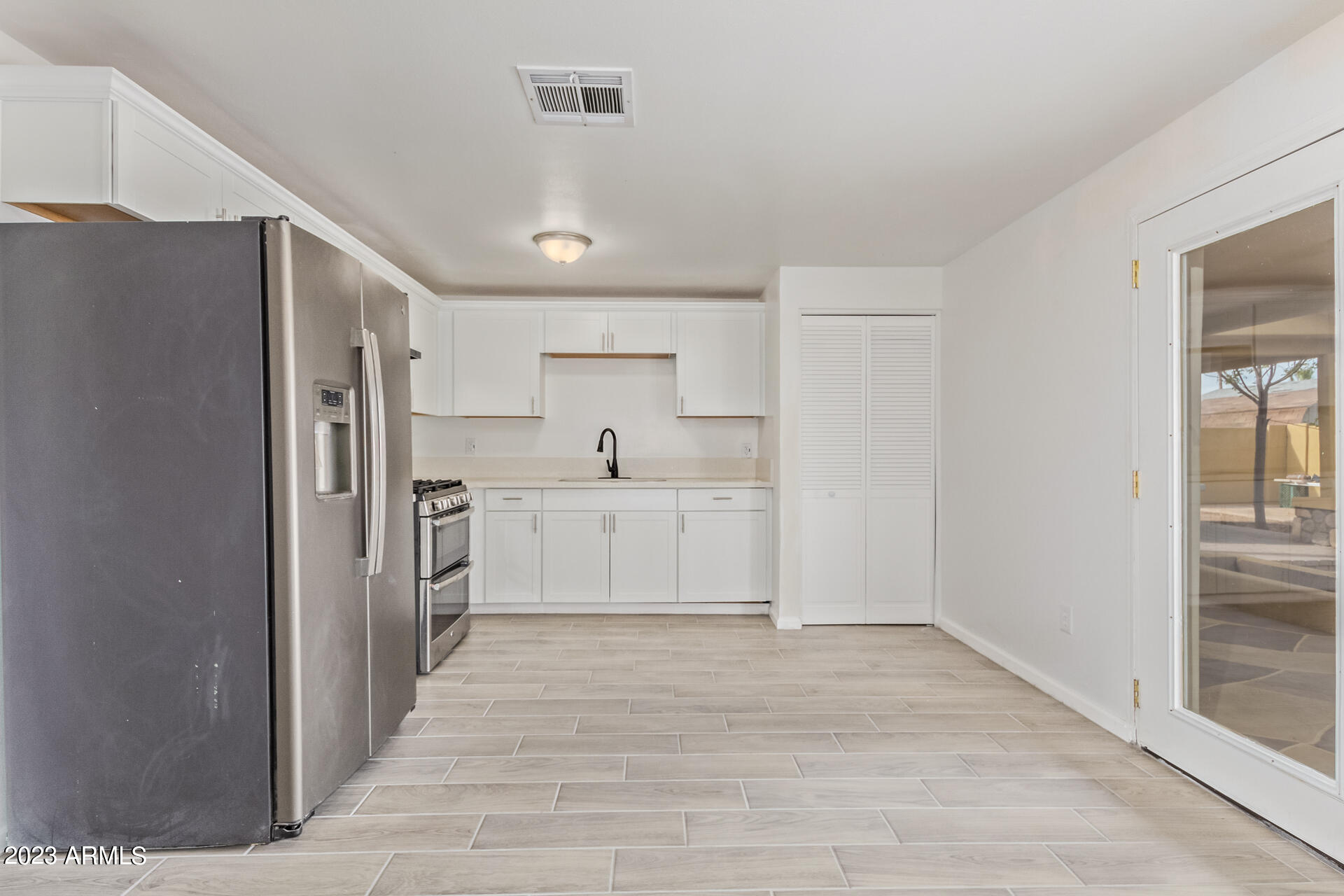 6532 West Granada Road Phoenix, AZ 85035 - Photo 10 of 31 a view of a kitchen with a sink and refrigerator