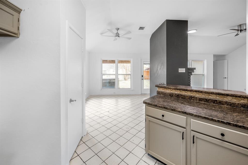 2218 Fuqua Road Rowlett, TX 75088 - Photo 13 of 30 a bathroom with a granite countertop sink and mirror