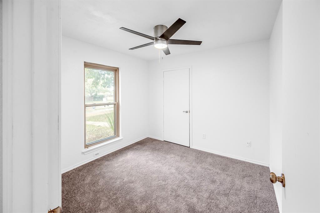 2218 Fuqua Road Rowlett, TX 75088 - Photo 14 of 30 an empty room with a window and a ceiling fan
