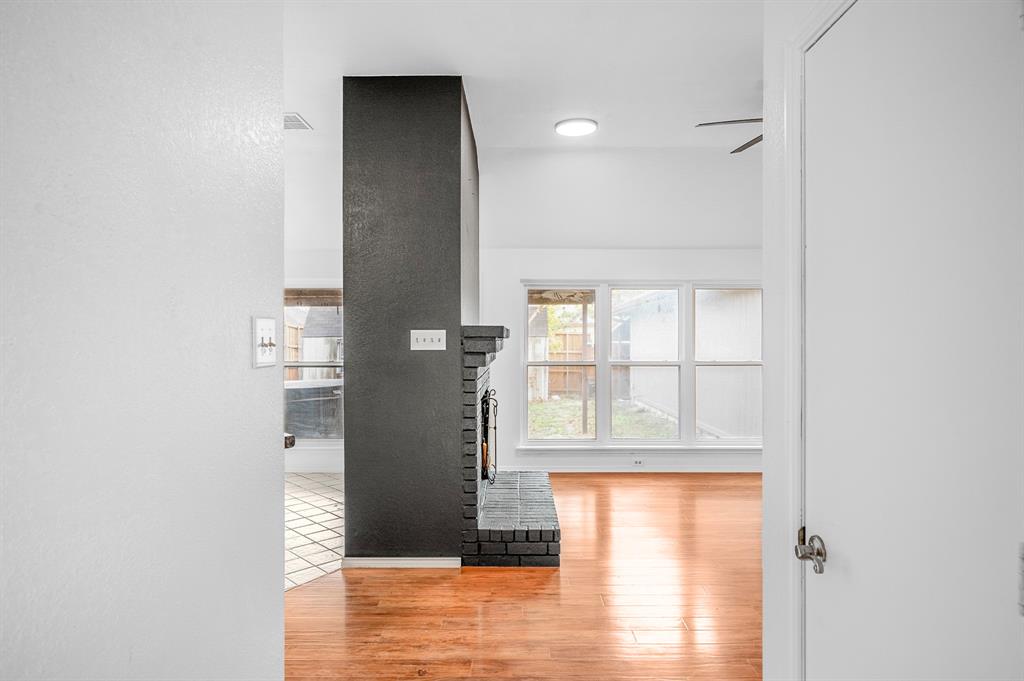2218 Fuqua Road Rowlett, TX 75088 - Photo 2 of 30 a view of empty room with wooden floor and floor to ceiling window