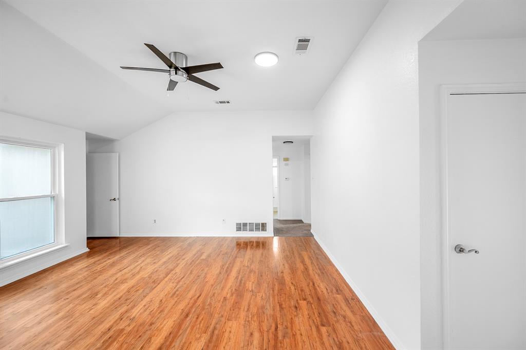 2218 Fuqua Road Rowlett, TX 75088 - Photo 3 of 30 a view of room with a ceiling fan and wooden floor