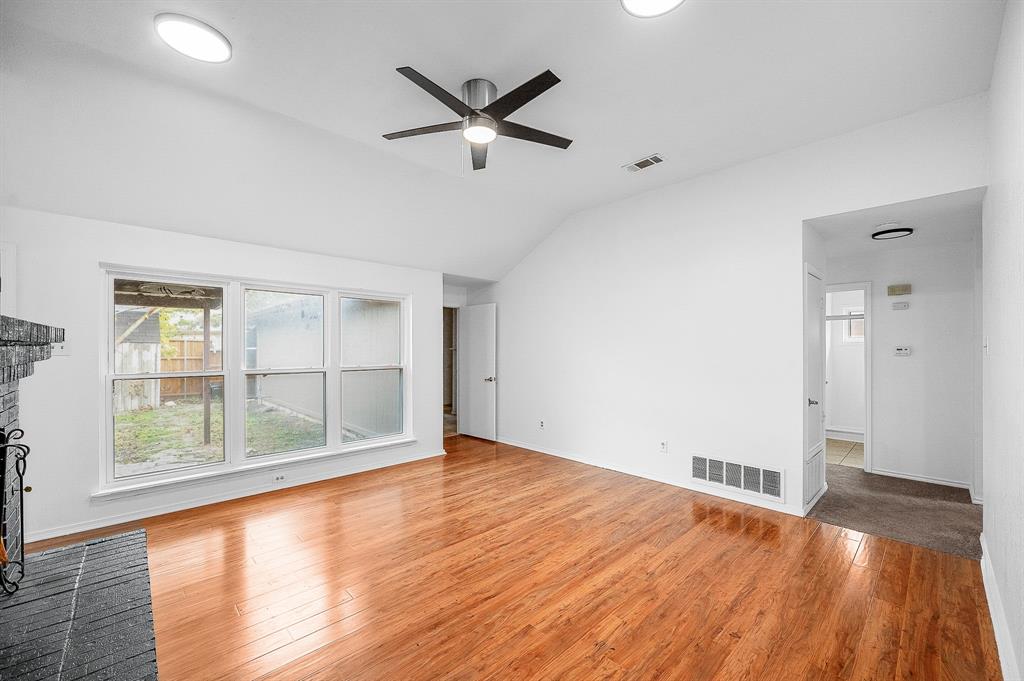 2218 Fuqua Road Rowlett, TX 75088 - Photo 4 of 30 an empty room with wooden floor and windows