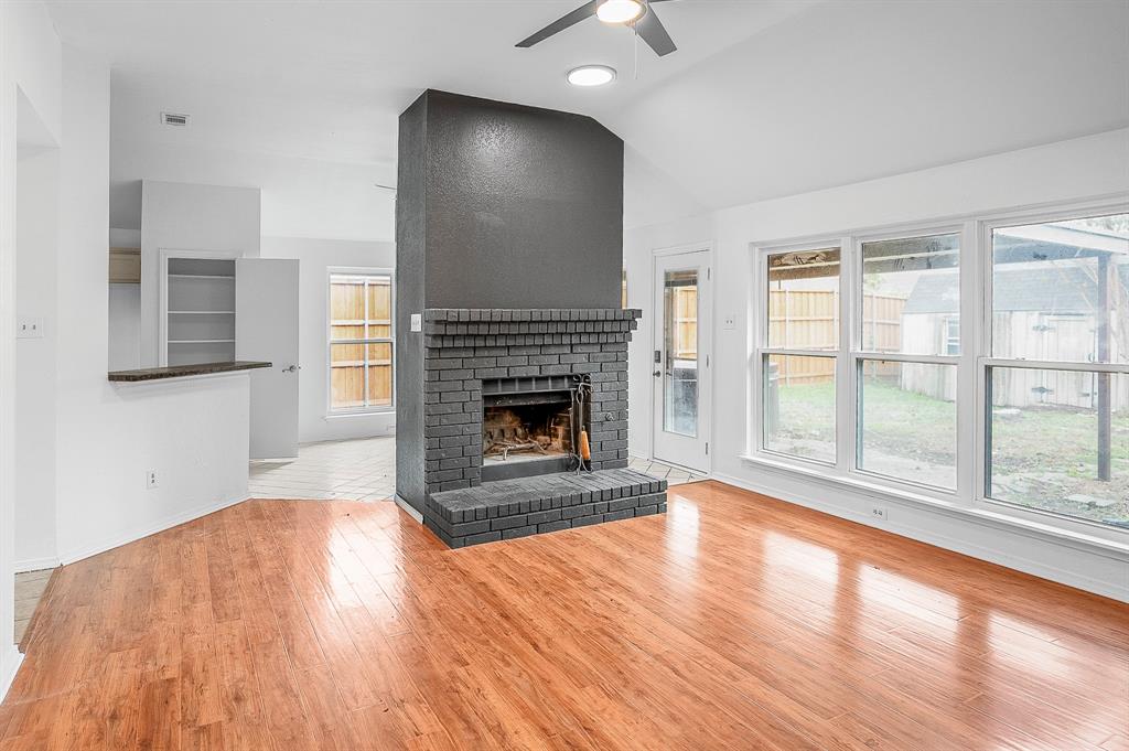 2218 Fuqua Road Rowlett, TX 75088 - Photo 6 of 30 a view of empty room with wooden floor and fireplace