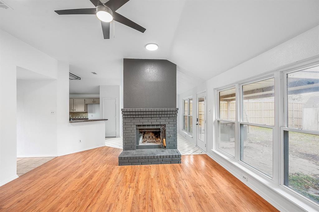 2218 Fuqua Road Rowlett, TX 75088 - Photo 8 of 30 wooden floor fireplace and natural light in room