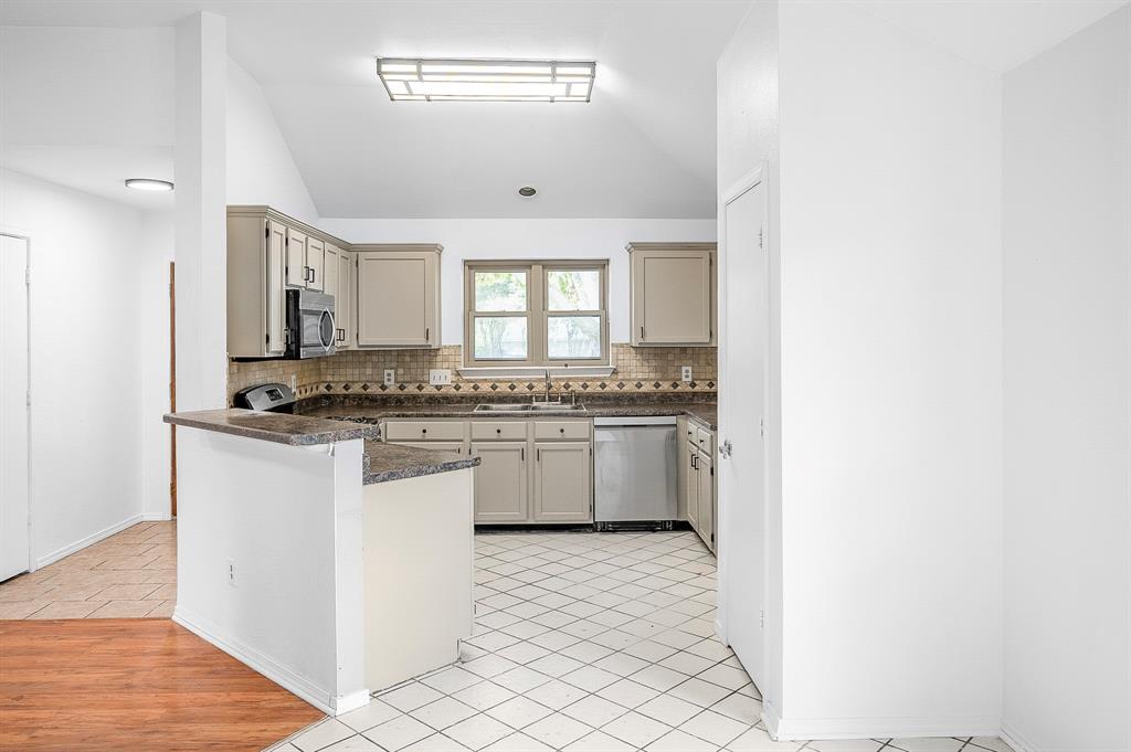 2218 Fuqua Road Rowlett, TX 75088 - Photo 10 of 30 a kitchen with granite countertop white cabinets and white appliances