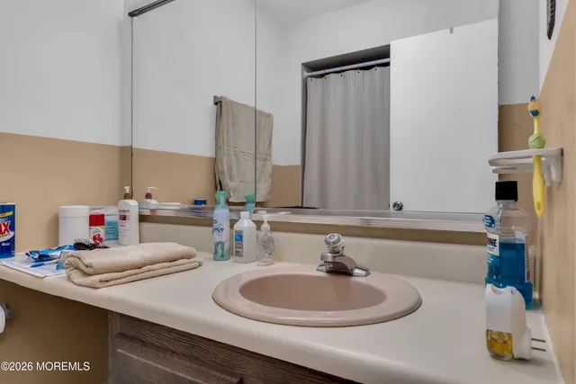 a bathroom with a double vanity sink and a mirror