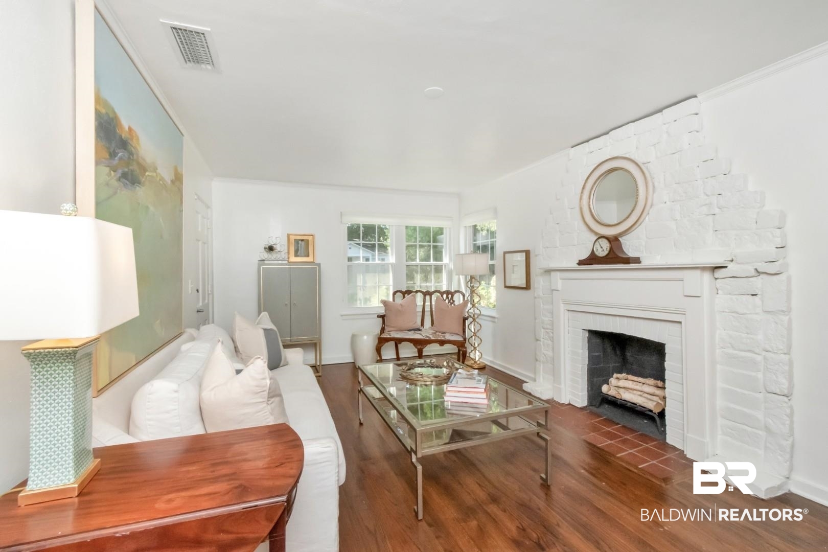 18 Princess Anne Road Mobile, AL 36608 - Photo 2 of 41 Living area with wood finished floors and a brick fireplace